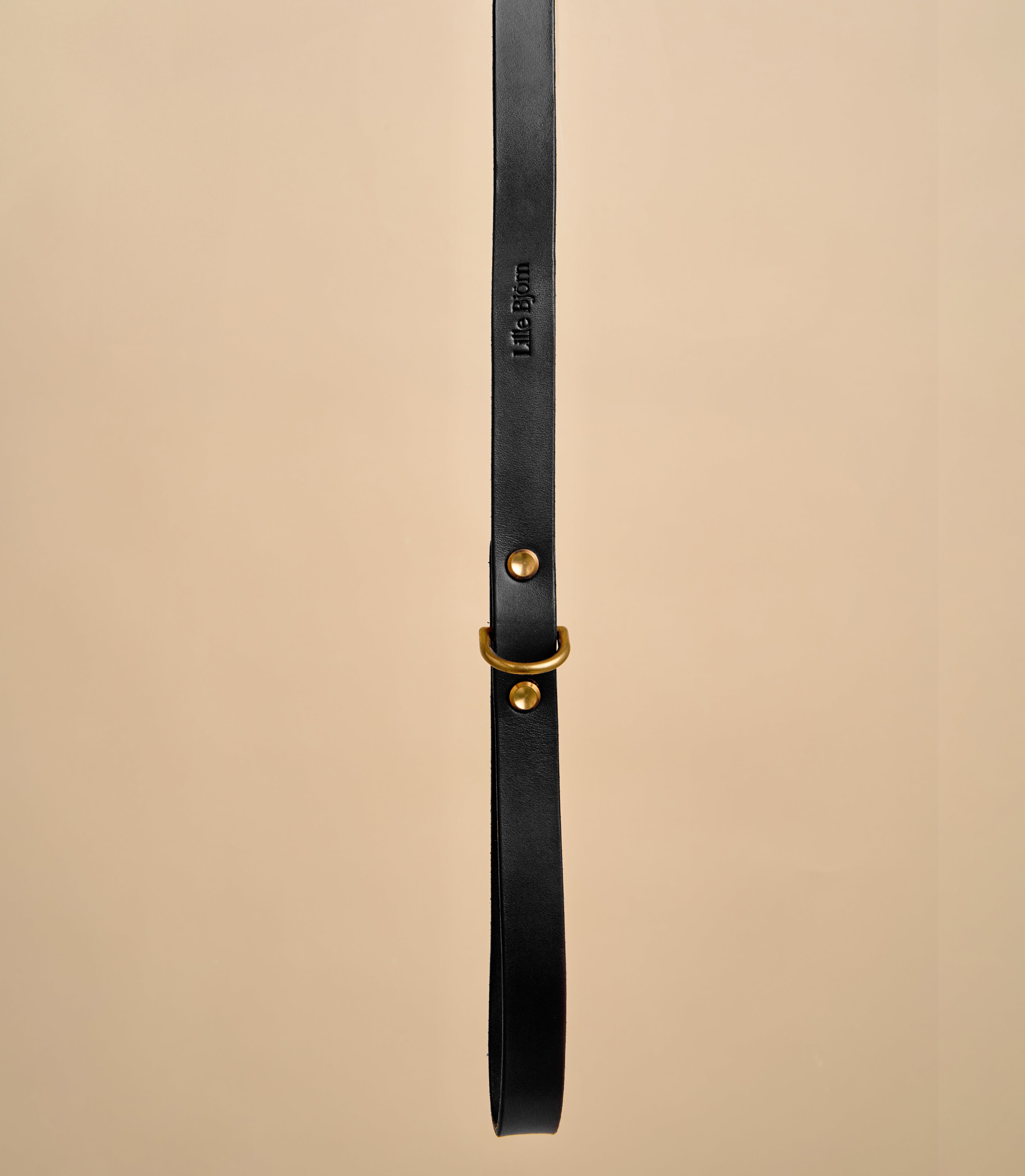 Close-up detail of Classic Black Leather Dog Leash handle with embossed design, featuring premium Italian leather and brass hardware