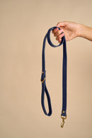 Full view of Classic Blue Leather Dog Leash held in hand, crafted from high-quality Italian leather with brass hardware for strength