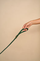 Classic Green Leather Dog Leash in hand, showcasing ease of handling, crafted from Italian leather and brass hardware