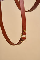 Close-up detail of Omni Cognac Leather Dog Leash for hands-free crossbody wear, featuring strong brass hardware