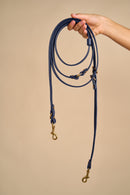 Full view of Omni Blue Leather Dog Leash held in hand, crafted from Italian leather with strong brass hardware for durability