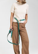 Omni Green Leather Dog Leash worn hands-free around the waist, featuring Italian leather and brass hardware