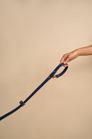 Omni Blue Leather Dog Leash held in hand, showcasing versatile wear options and sturdy brass hardware