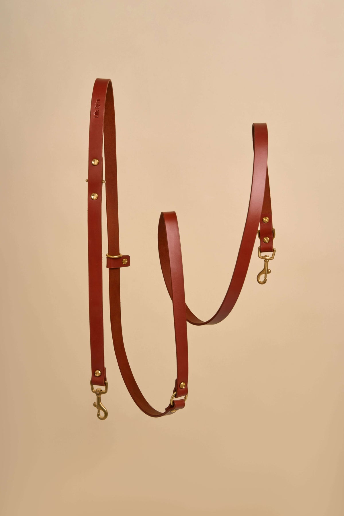Omni Cognac Leather Dog Leash designed for hands-free and cross-body use, made from luxurious Italian leather with durable brass hardware, offering a stylish and adaptable solution for walking your dog
