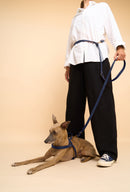 Omni Blue Leather Dog Leash worn hands-free around the waist, featuring high-quality brass hardware and adjustable fit