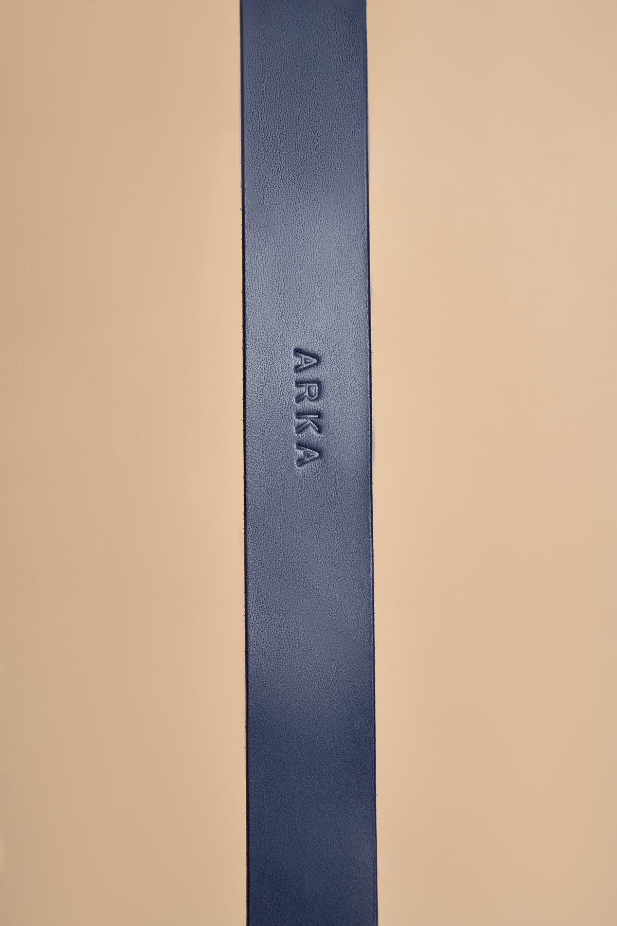 Detailed view of name embossing on Vero Classic Blue Leather Dog Collar, highlighting personalized custom options on premium Italian leather
